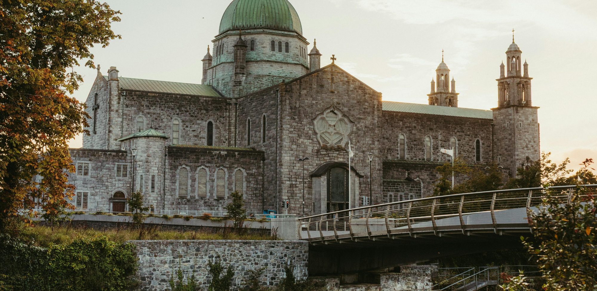 Beautiful view of Galway Cathedral and Corrib River at sunset in Galway, Ireland.